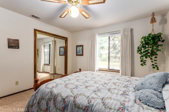 carpeted bedroom featuring a closet and ceiling fan