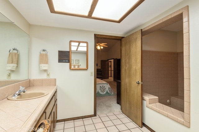 bathroom featuring vanity, ceiling fan, tile patterned floors, and tiled shower