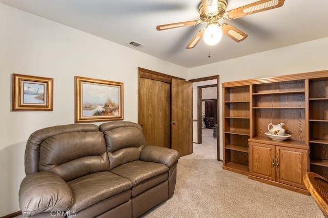 living room with light colored carpet and ceiling fan