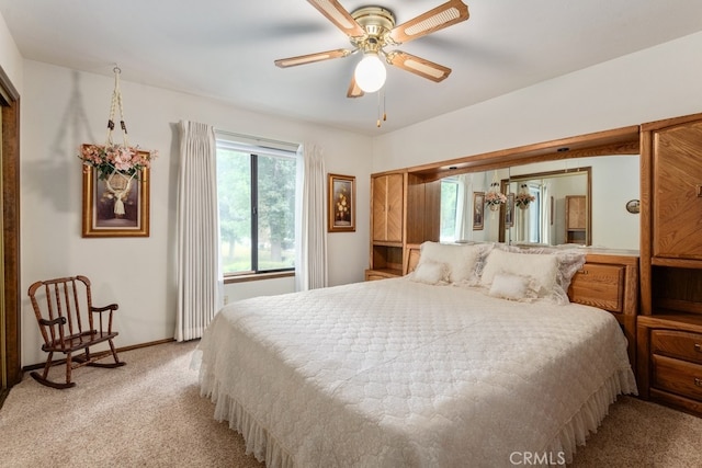 bedroom featuring ceiling fan and light colored carpet