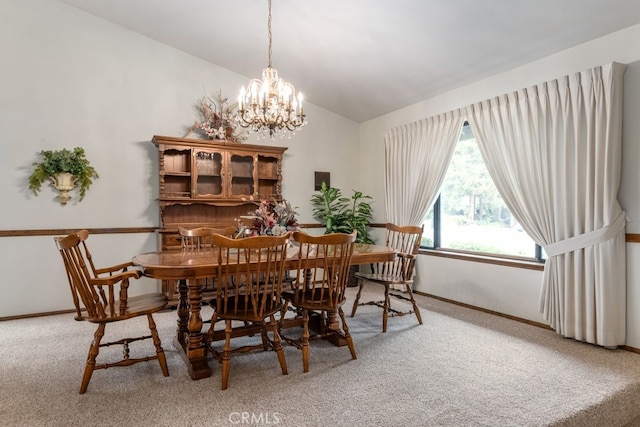 dining area featuring an inviting chandelier, carpet, and vaulted ceiling