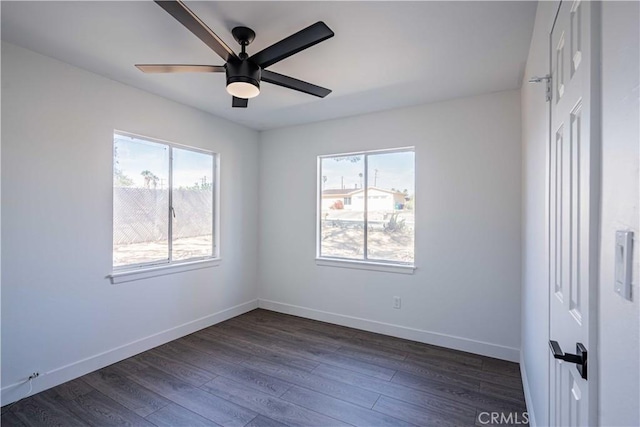 spare room featuring ceiling fan and dark hardwood / wood-style floors