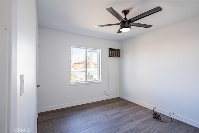 spare room with ceiling fan, dark wood-type flooring, and a wall unit AC