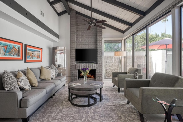 living room featuring beam ceiling, wooden ceiling, a brick fireplace, high vaulted ceiling, and ceiling fan