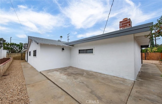 view of side of property with a patio