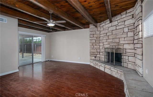 unfurnished living room with ceiling fan, beam ceiling, wood-type flooring, wood ceiling, and a stone fireplace