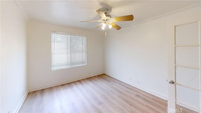 unfurnished room featuring ornamental molding, light wood-type flooring, and ceiling fan