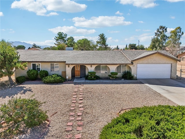 single story home featuring a garage and a mountain view