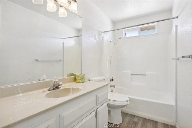 full bathroom with vanity, bathtub / shower combination, hardwood / wood-style flooring, and toilet