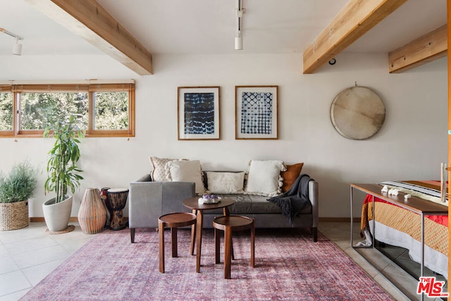 tiled living room with track lighting and beam ceiling