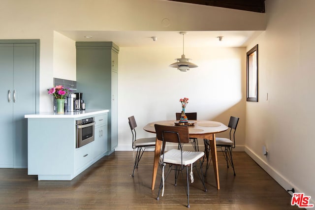 dining space with dark wood-type flooring and vaulted ceiling