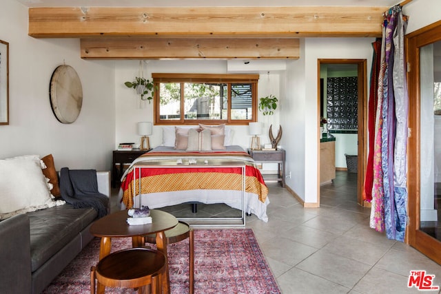 tiled bedroom featuring beamed ceiling