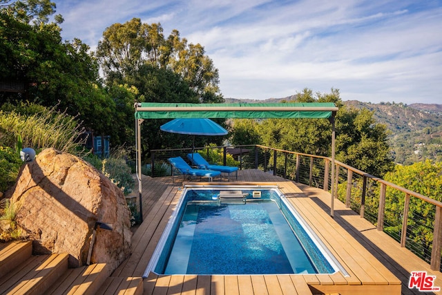 view of swimming pool featuring a deck