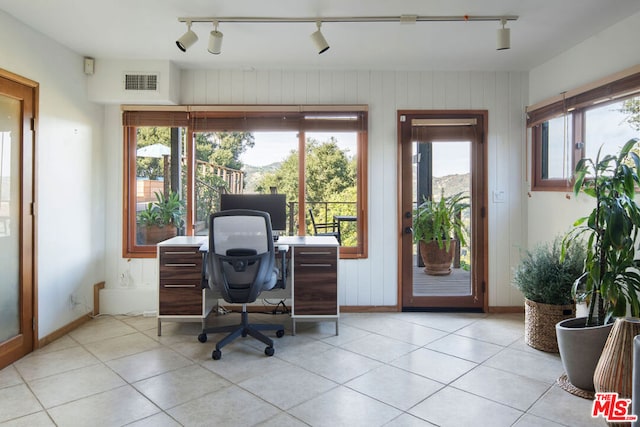 tiled home office featuring wooden walls