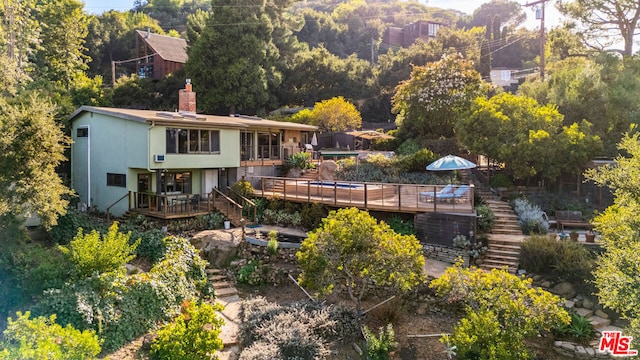 back of house with a wooden deck