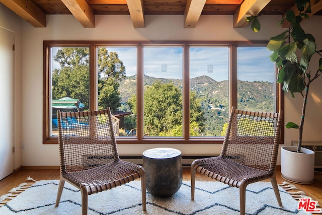 sunroom with beam ceiling, wood ceiling, and a mountain view