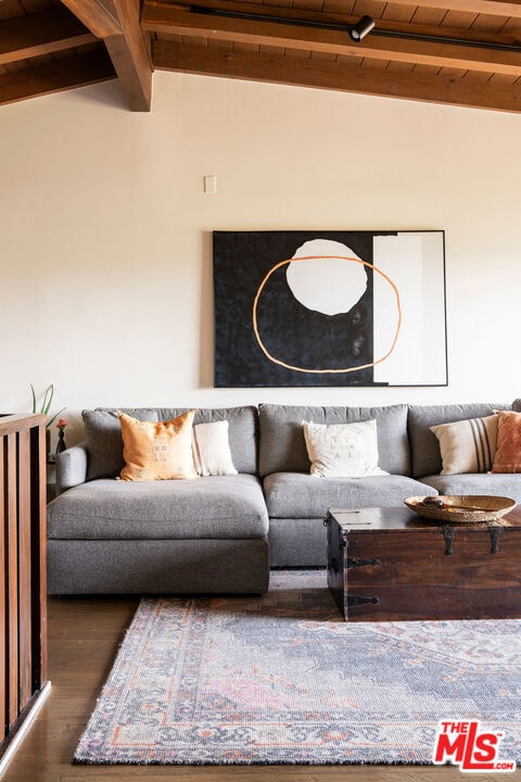 living room with dark wood-type flooring, wooden ceiling, and vaulted ceiling with beams