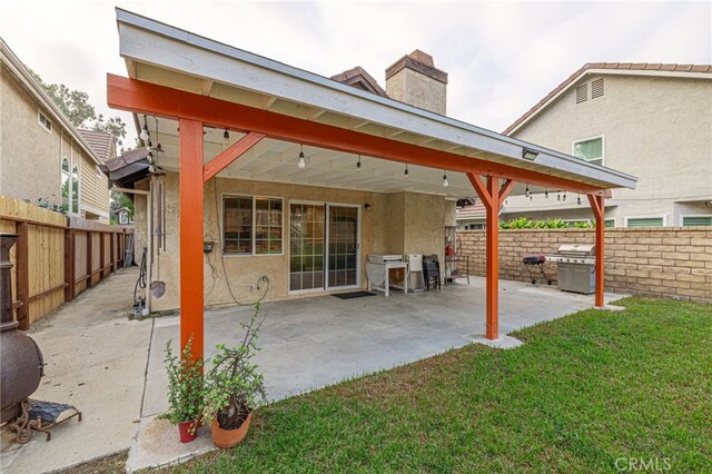 rear view of property with a patio and a yard