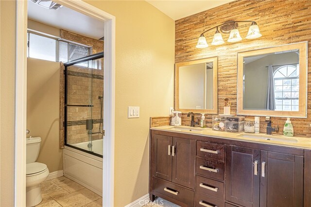 full bathroom with vanity, toilet, and enclosed tub / shower combo