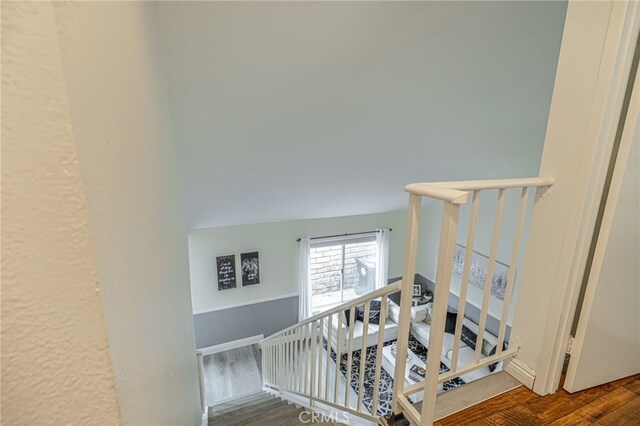 stairway with hardwood / wood-style floors