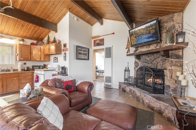 tiled living room with sink, a stone fireplace, beamed ceiling, wooden ceiling, and high vaulted ceiling