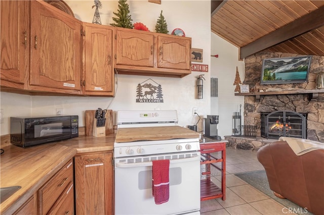 kitchen featuring a fireplace, wood ceiling, lofted ceiling with beams, white stove, and light tile patterned floors