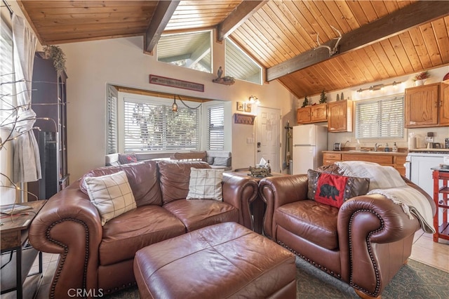 tiled living room with a healthy amount of sunlight, lofted ceiling with beams, and wooden ceiling