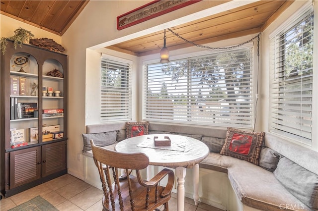 dining room with lofted ceiling, wood ceiling, and a healthy amount of sunlight