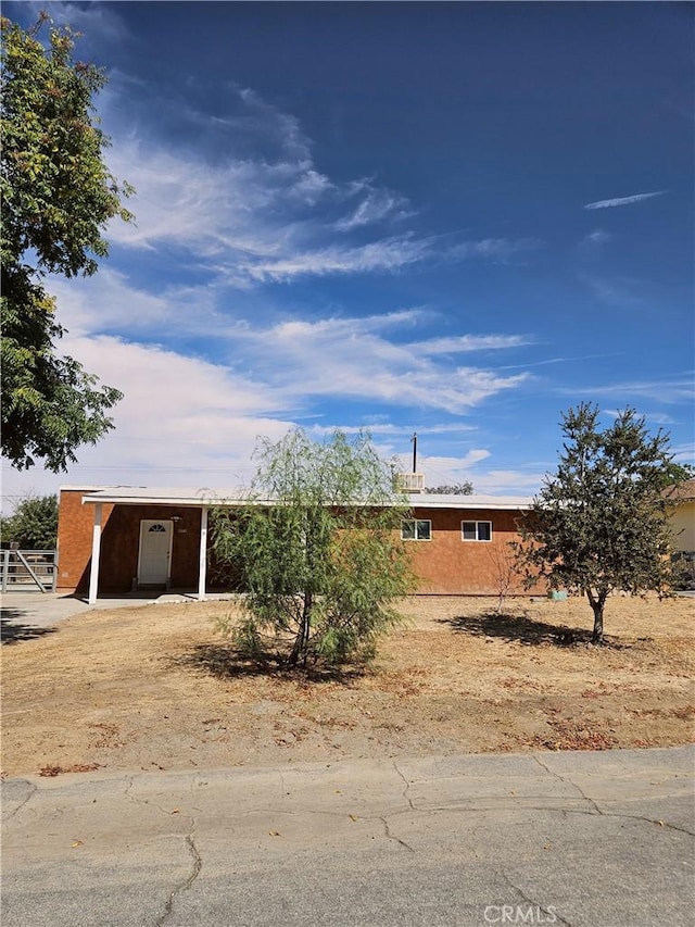 4772 Cebrian, New Cuyama, CA 93254 - view of front of home with a carport, stucco siding, and driveway