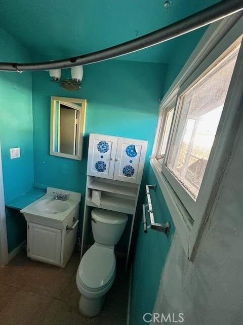 bathroom with vanity, toilet, and tile patterned flooring