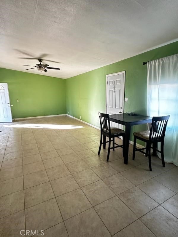 4772 Cebrian, New Cuyama, CA 93254 - tiled dining area featuring a ceiling fan, vaulted ceiling, and a textured ceiling