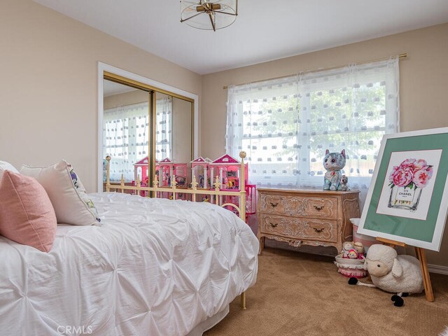 carpeted bedroom featuring a closet and multiple windows