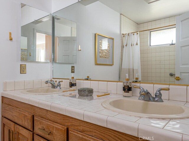 bathroom featuring vanity and a shower with shower curtain