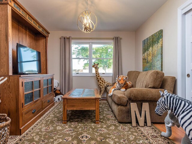 living room with hardwood / wood-style floors and a chandelier