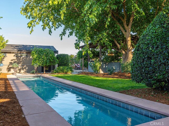 view of swimming pool featuring a lawn