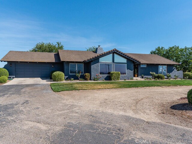 ranch-style house with a front lawn and a garage