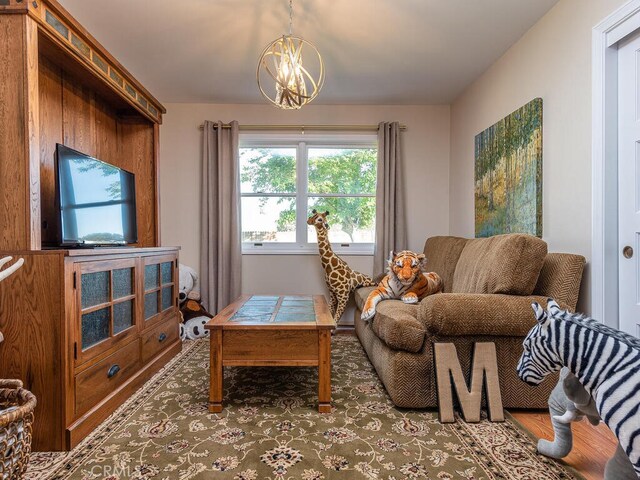 living room with a notable chandelier and hardwood / wood-style flooring