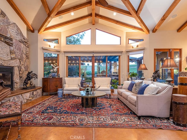 living room featuring a healthy amount of sunlight, beamed ceiling, a fireplace, and high vaulted ceiling