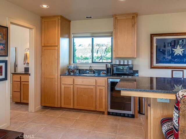 kitchen with sink, light tile patterned floors, and beverage cooler