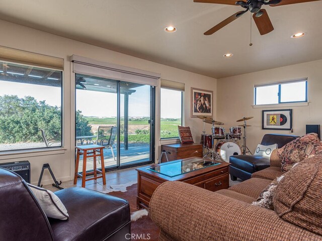 living room with ceiling fan and a wealth of natural light