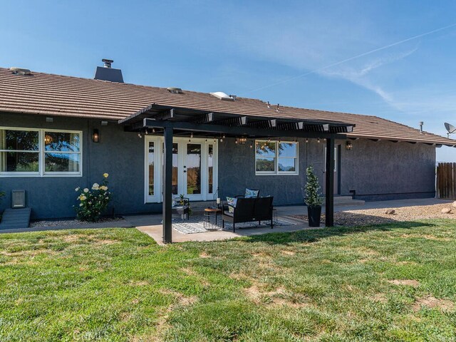 back of house with a patio, a pergola, and a lawn