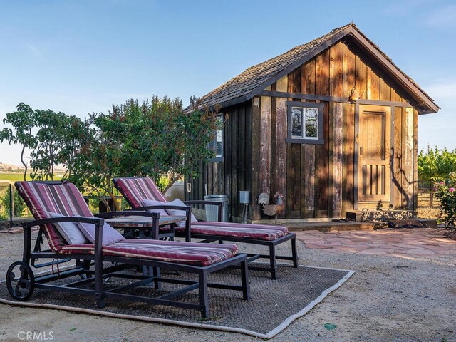 view of patio / terrace featuring an outbuilding