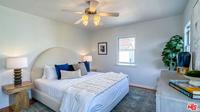 bedroom featuring ceiling fan and dark hardwood / wood-style flooring