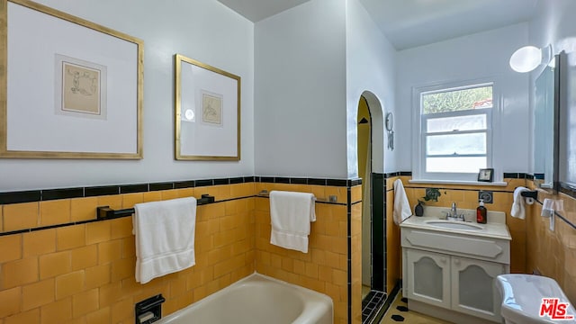 bathroom featuring tile walls, vanity, separate shower and tub, and tile patterned flooring