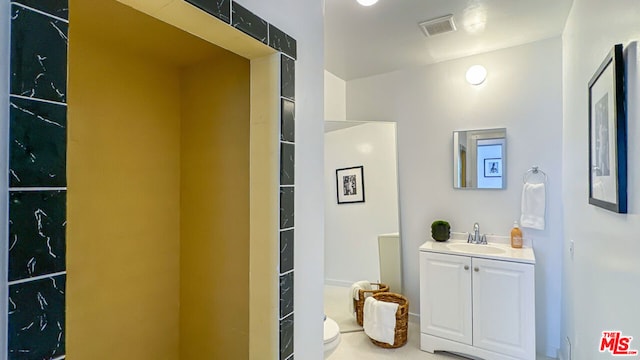 bathroom with vanity and toilet