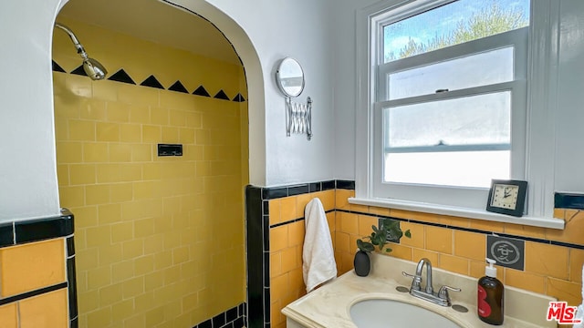 bathroom featuring vanity, tile walls, and a wealth of natural light