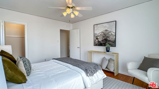 bedroom with wood-type flooring and ceiling fan