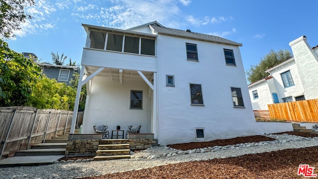 rear view of property with a sunroom