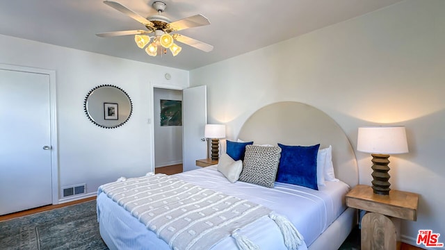 bedroom featuring dark hardwood / wood-style flooring and ceiling fan