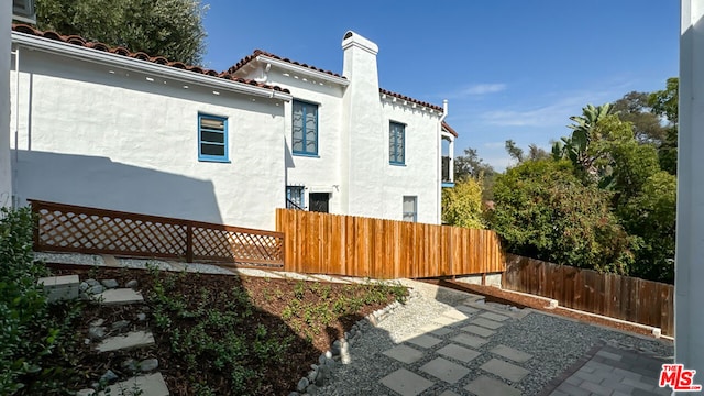 view of side of property featuring a patio area